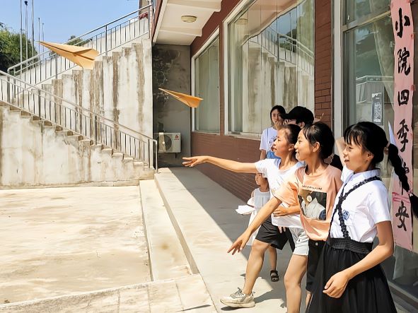 d08e4031ed4349baa39a9574ab543c49.jpg 孩子们进行纸飞机比赛.jpg